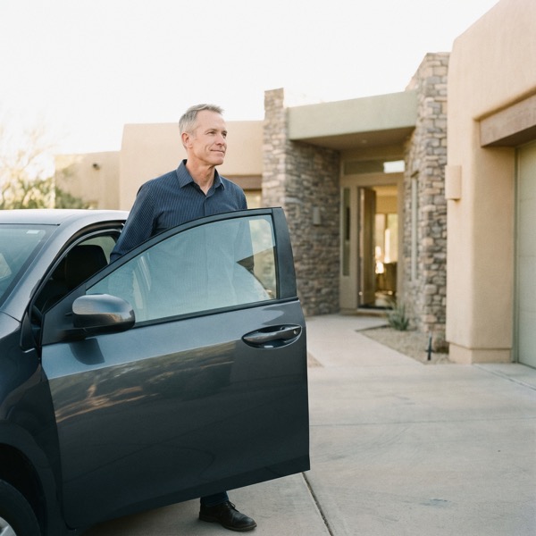 A man stepping out of his car